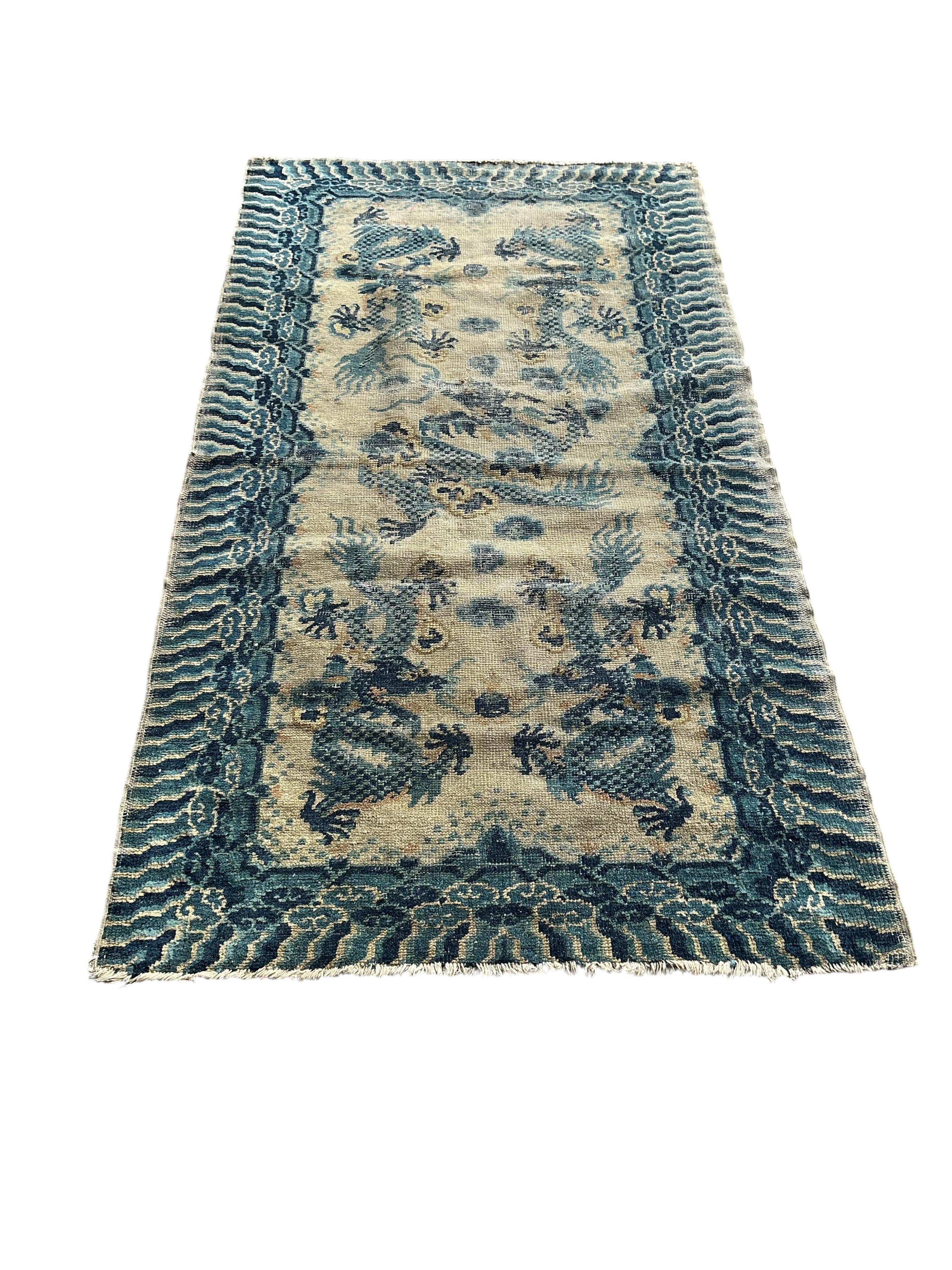 A Chinese ivory ground dragon palace rug, Qing Dynasty, 148 x 79cm